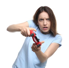 Emotional woman playing video game with controller on white background