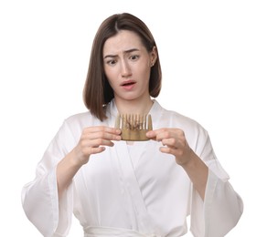 Emotional woman holding comb with lost hair on white background. Alopecia problem