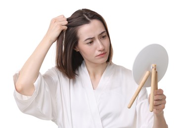 Sad woman with hair loss problem looking at mirror on white background