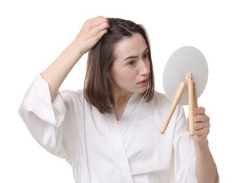 Photo of Sad woman with hair loss problem looking at mirror on white background