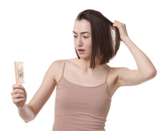 Photo of Stressed woman holding comb with lost hair on white background. Alopecia problem