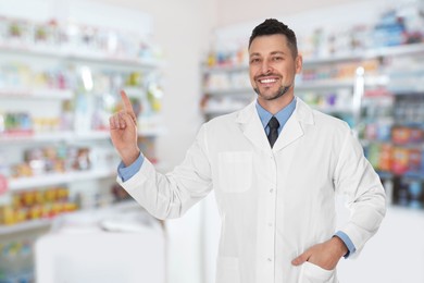 Image of Pharmacist in drugstore. Happy man in uniform indoors