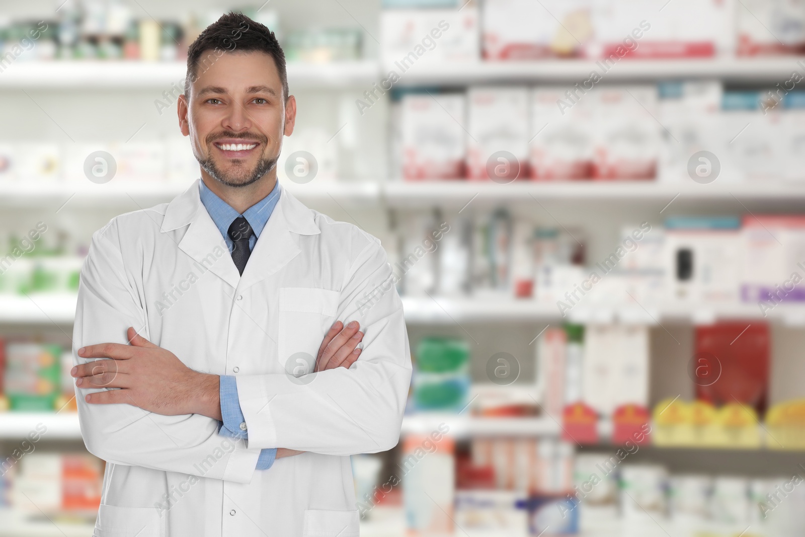 Image of Positive pharmacist in uniform at drugstore. Space for text