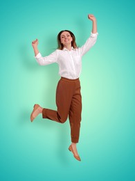 Image of Positive young woman jumping on turquoise gradient background