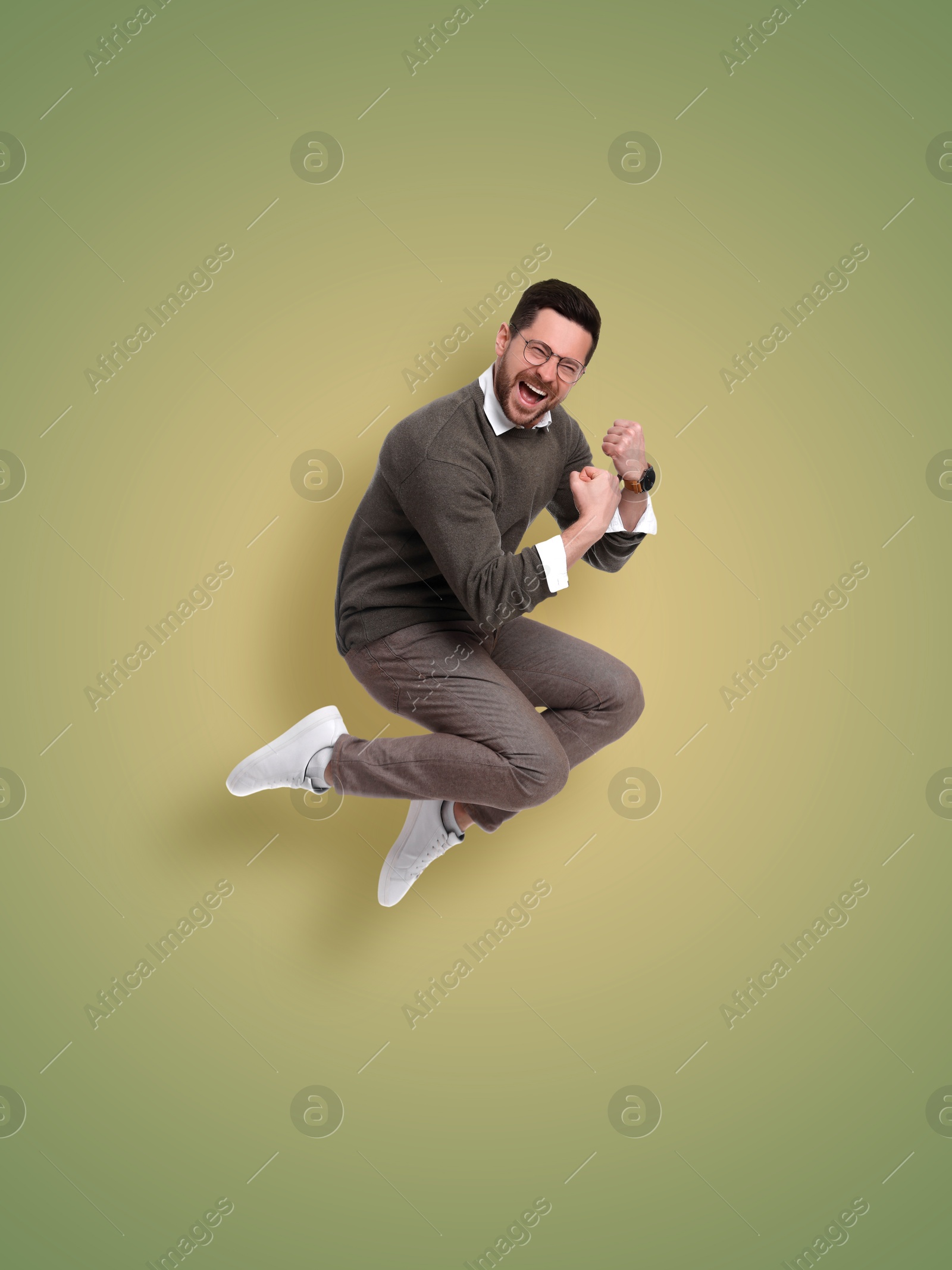 Image of Positive man jumping on color gradient background