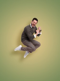 Image of Positive man jumping on color gradient background