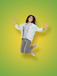 Image of Positive young woman jumping on yellow green gradient background