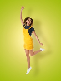 Positive young woman jumping on light green gradient background