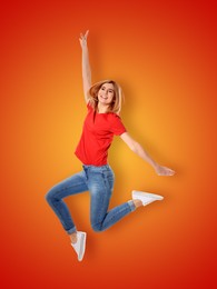 Image of Positive young woman jumping on red orange gradient background