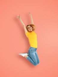 Image of Positive woman jumping on beige pink background