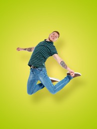 Image of Positive young man jumping on light green background