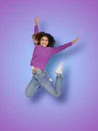 Positive young woman jumping on blue purple gradient background
