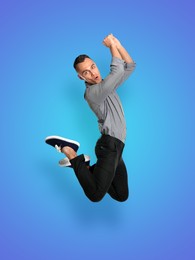 Positive young man jumping on blue background