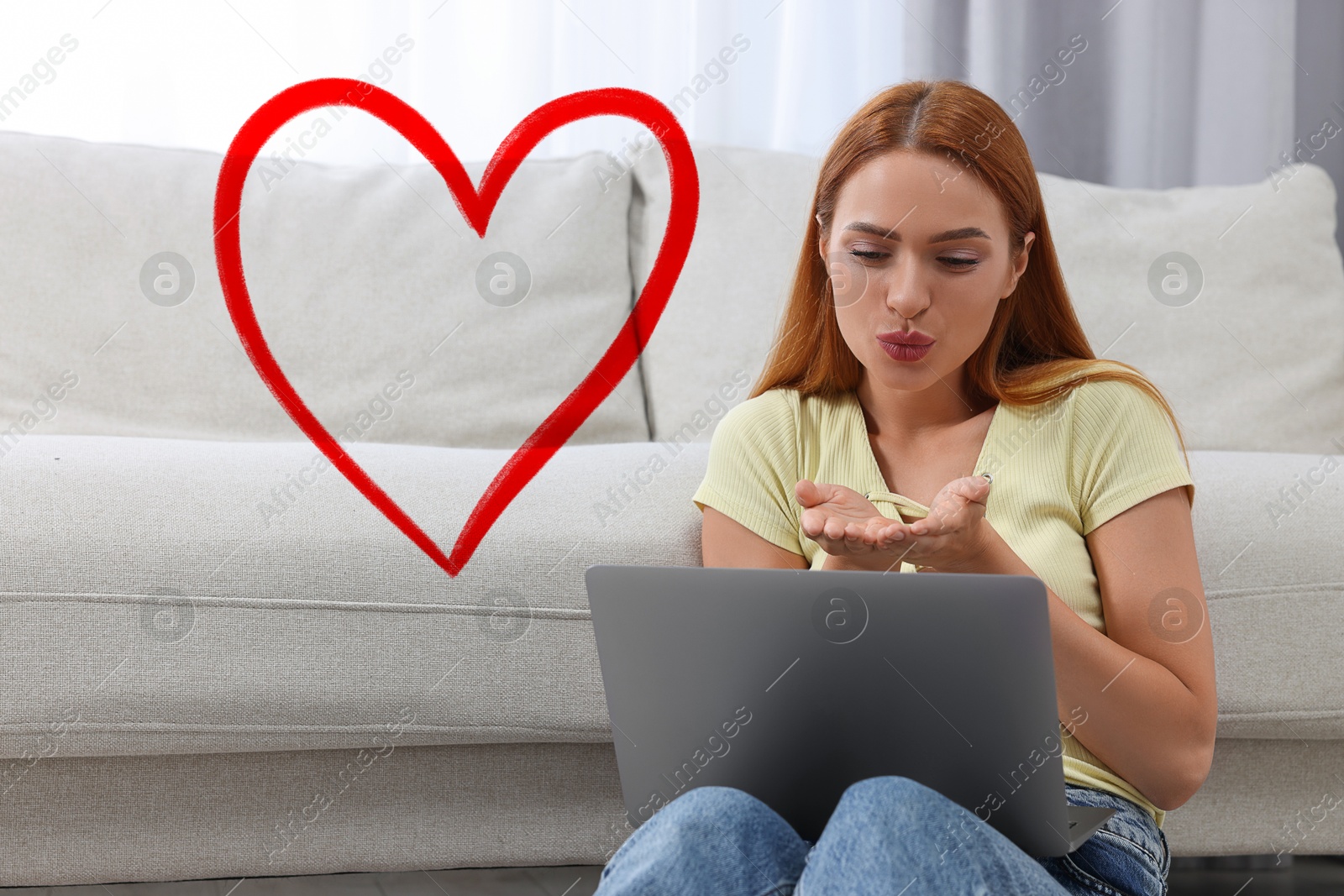 Image of Long distance relationship. Young woman sending air kiss to her loved one via video chat indoors. Red heart near her