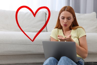 Image of Long distance relationship. Young woman sending air kiss to her loved one via video chat indoors. Red heart near her