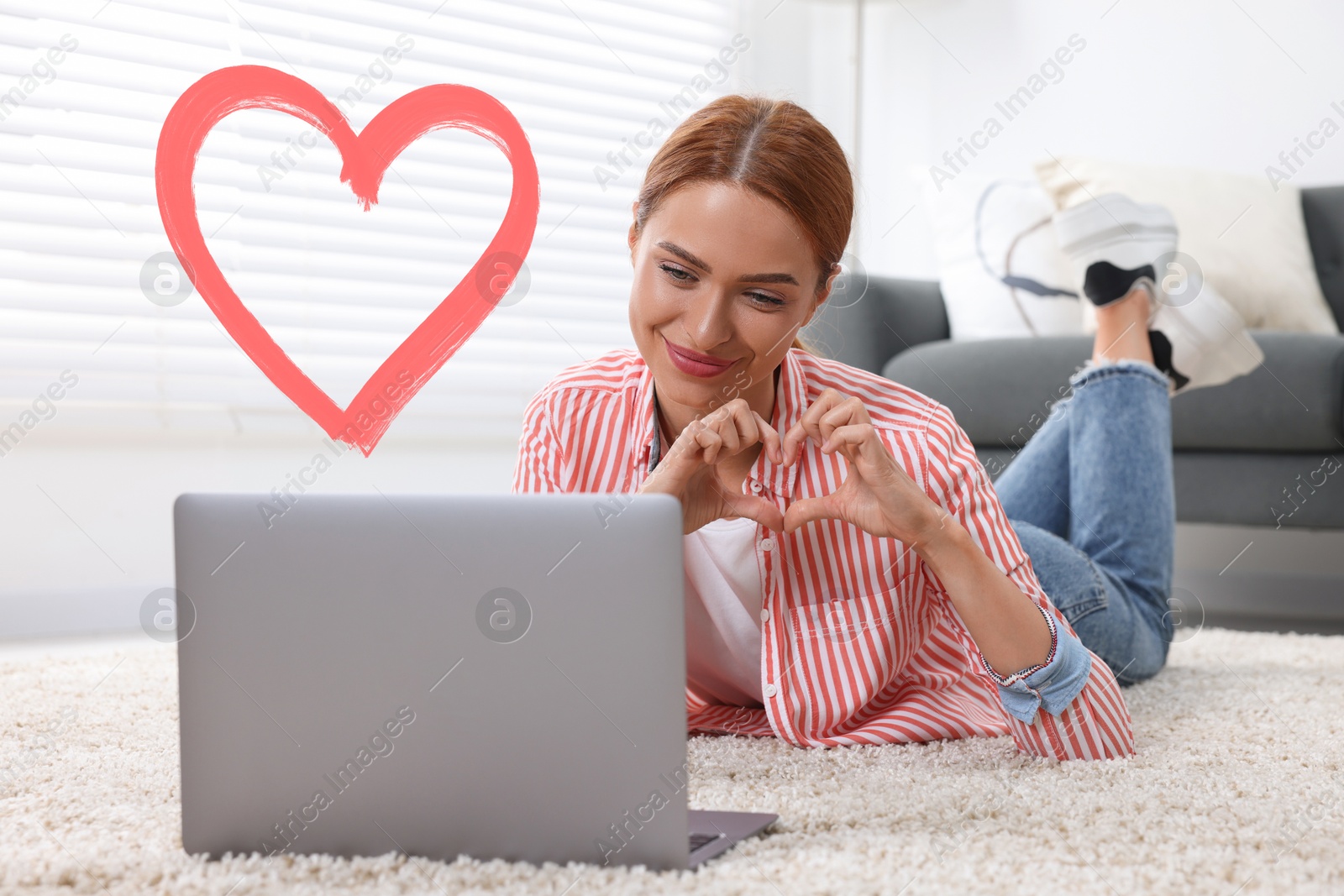 Image of Long distance relationship. Young woman having video chat with her loved one indoors. Red heart near her