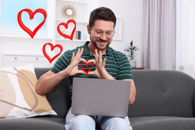 Image of Long distance relationship. Man having video chat with his loved one indoors. Red hearts near him