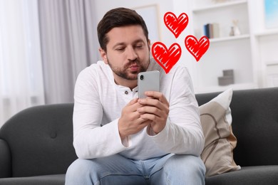 Long distance relationship. Man sending air kiss to his loved one via video chat indoors. Red hearts near him