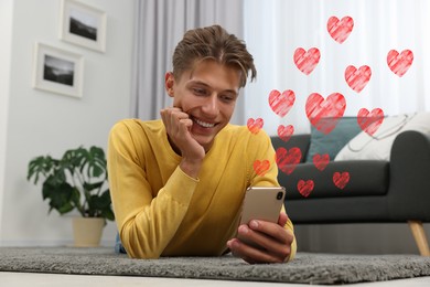 Long distance relationship. Young man talking to his loved one via video chat indoors. Red hearts near him