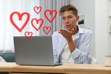 Long distance relationship. Young man sending air kiss to his loved one via video chat indoors. Red hearts near him