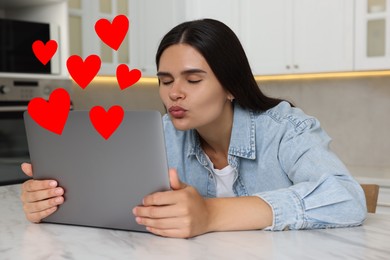 Image of Long distance relationship. Young woman sending air kiss to her loved one via video chat indoors. Red hearts near her
