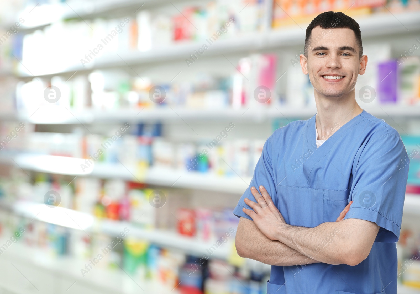 Image of Positive pharmacist in uniform at drugstore. Space for text