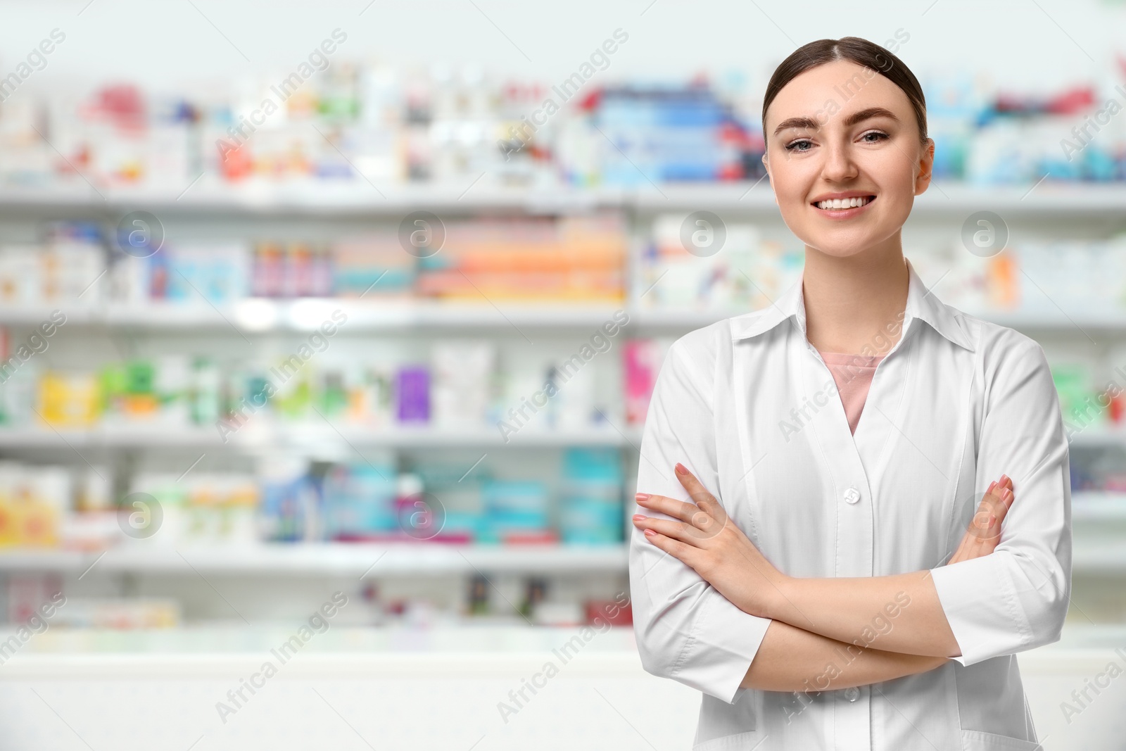 Image of Positive pharmacist in uniform at drugstore. Space for text