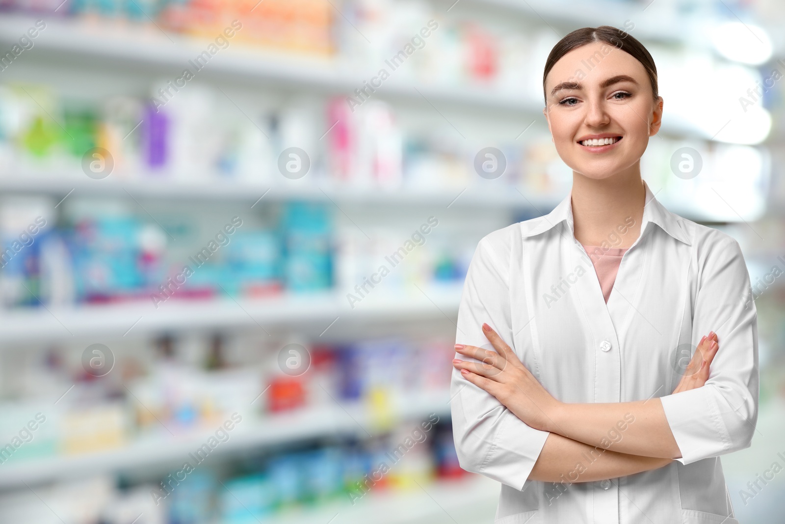 Image of Positive pharmacist in uniform at drugstore. Space for text