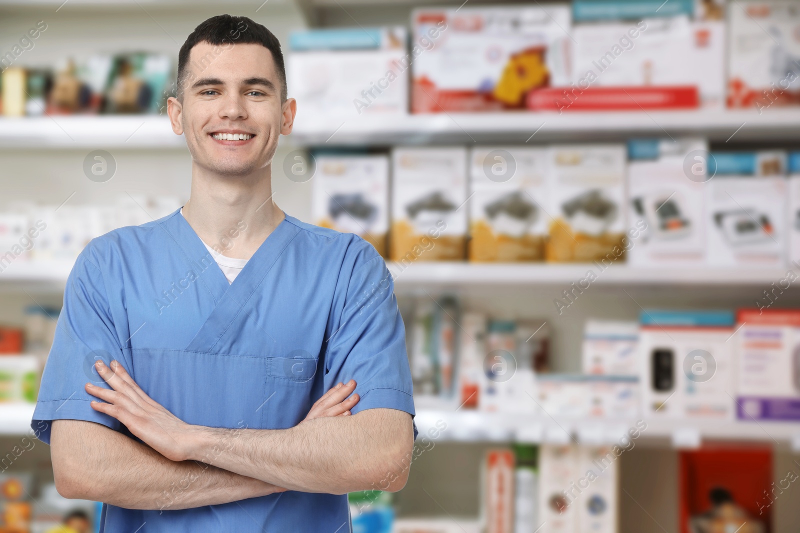 Image of Positive pharmacist in uniform at drugstore. Space for text