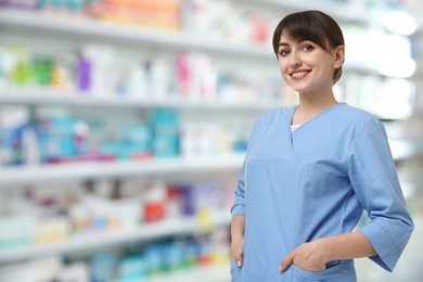 Positive pharmacist in uniform at drugstore. Space for text