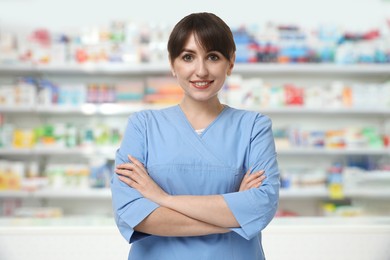 Image of Pharmacist in drugstore. Happy woman in uniform indoors