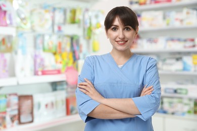 Positive pharmacist in uniform at drugstore. Space for text