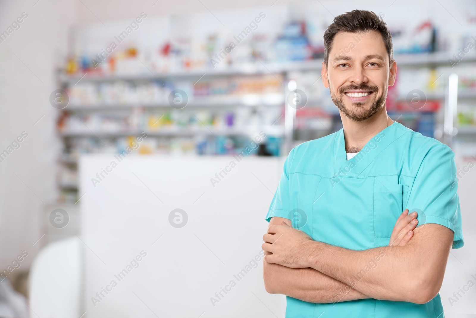 Image of Positive pharmacist in uniform at drugstore. Space for text