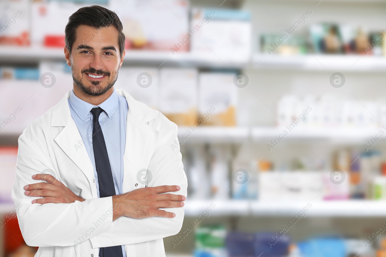 Image of Positive pharmacist in uniform at drugstore. Space for text