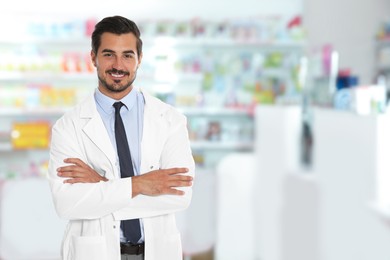 Positive pharmacist in uniform at drugstore. Space for text