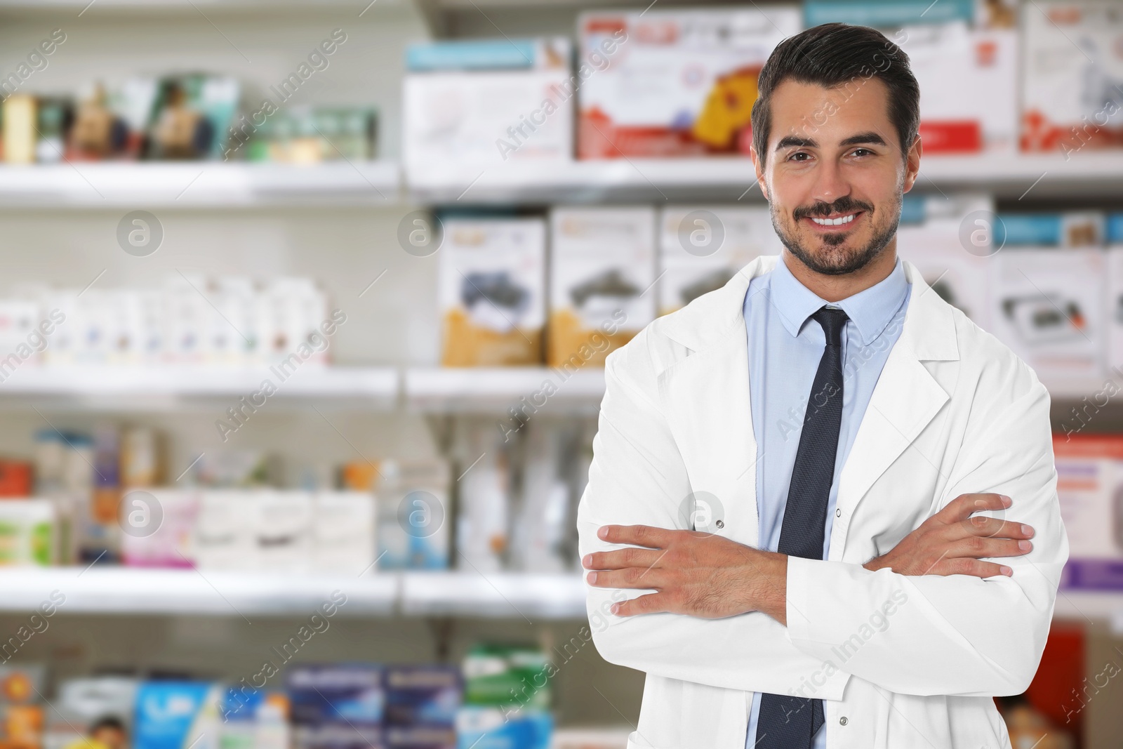 Image of Positive pharmacist in uniform at drugstore. Space for text