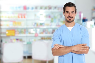 Positive pharmacist in uniform at drugstore. Space for text