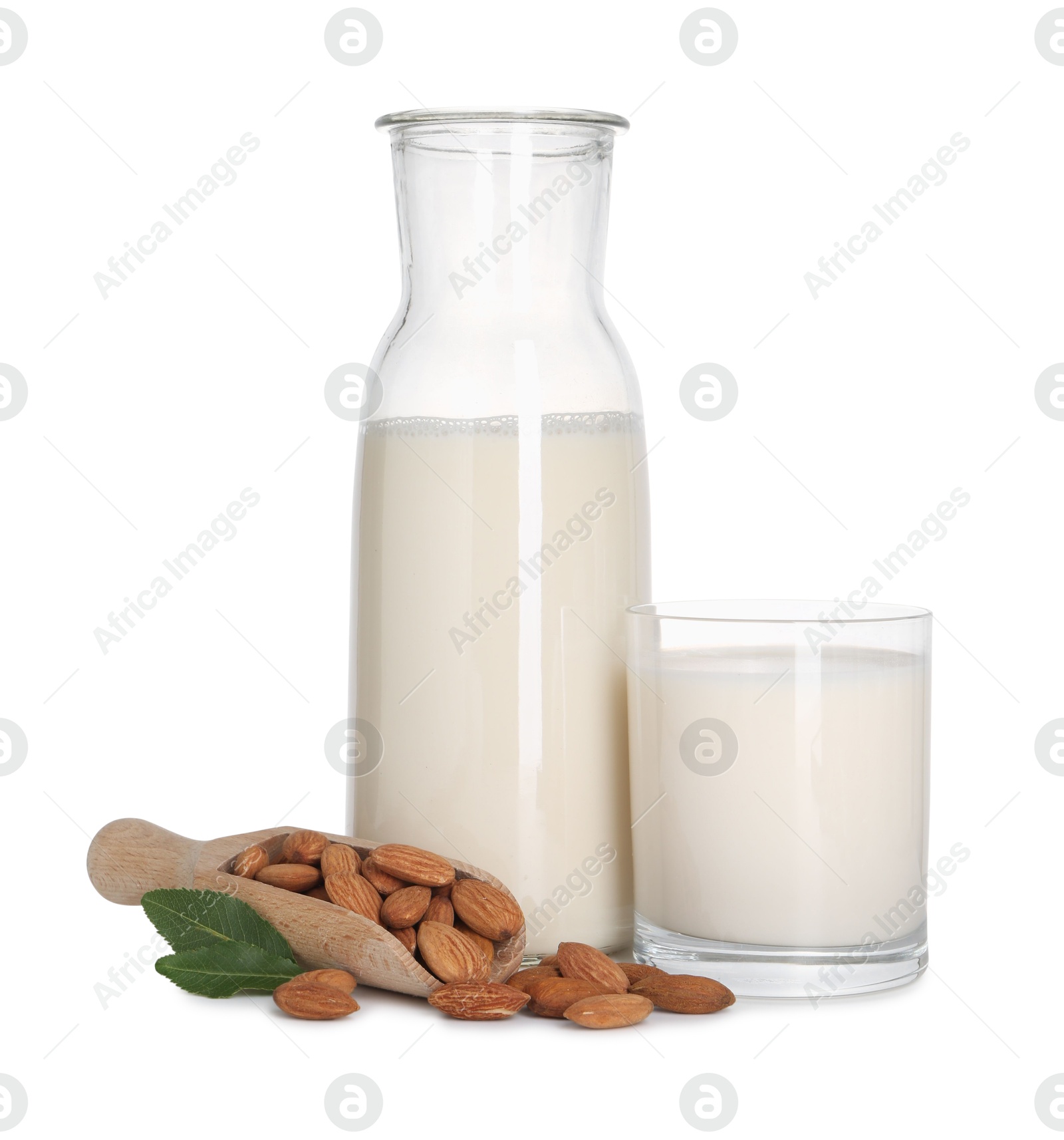 Photo of Glass of almond milk, jug and almonds isolated on white