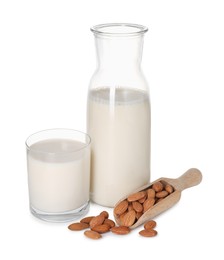 Photo of Glass of almond milk, jug and almonds isolated on white