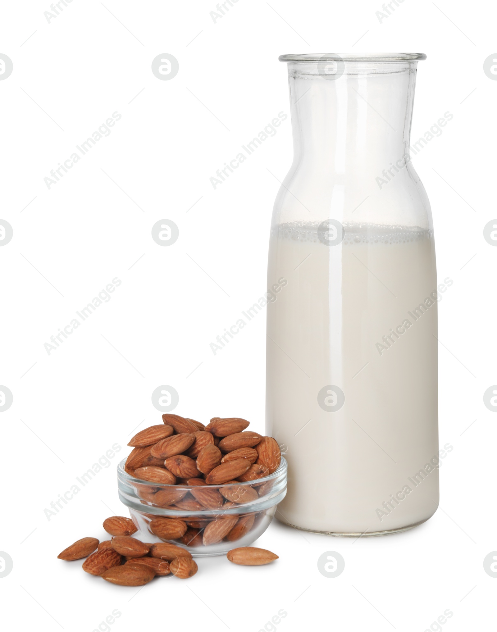 Photo of Glass jug of almond milk and almonds isolated on white