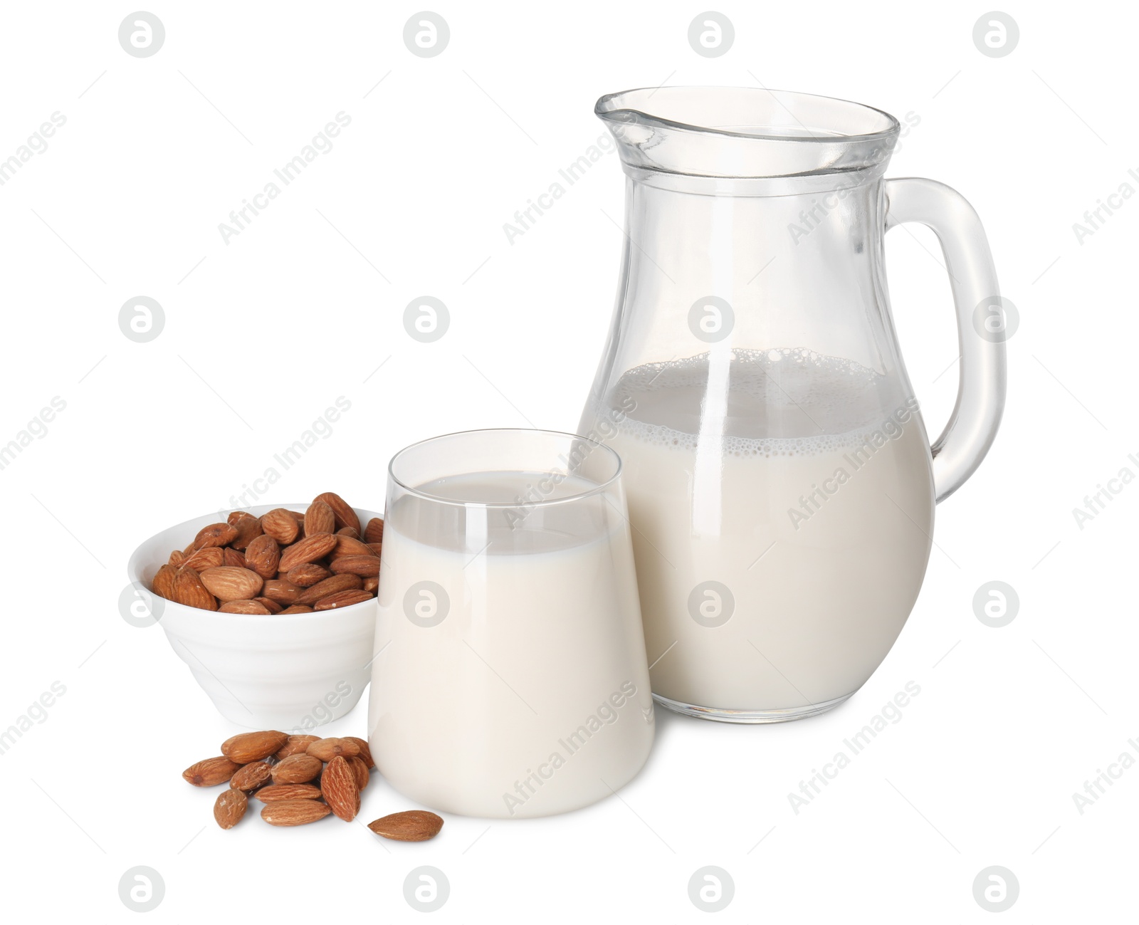 Photo of Glass of almond milk, jug and almonds isolated on white