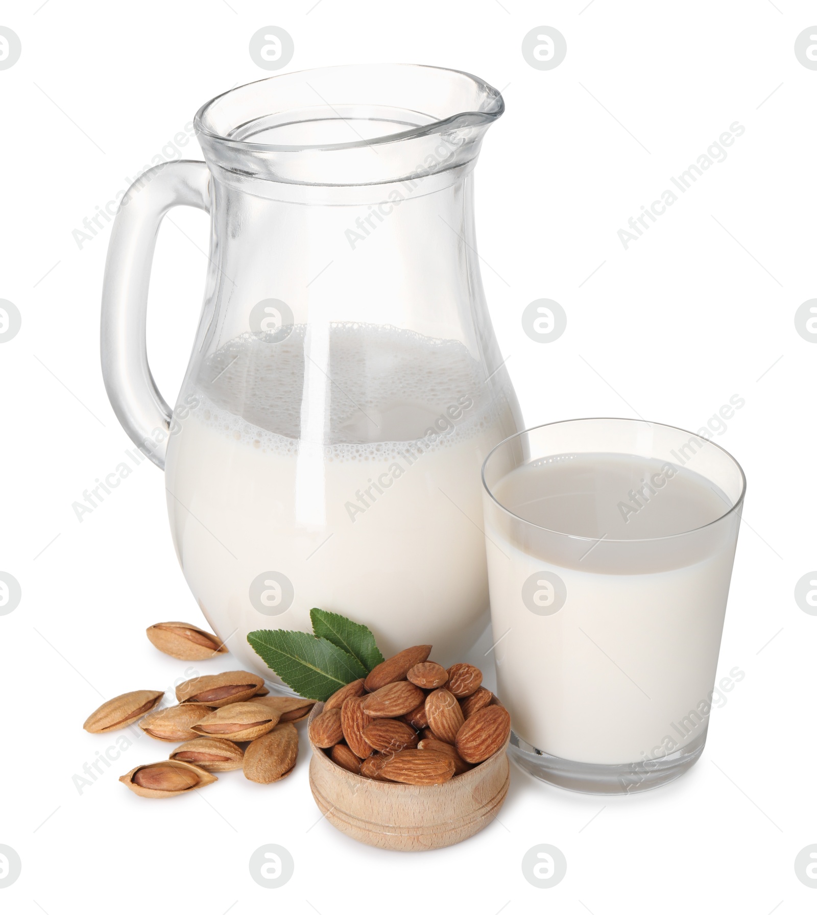 Photo of Glass of almond milk, jug and almonds isolated on white