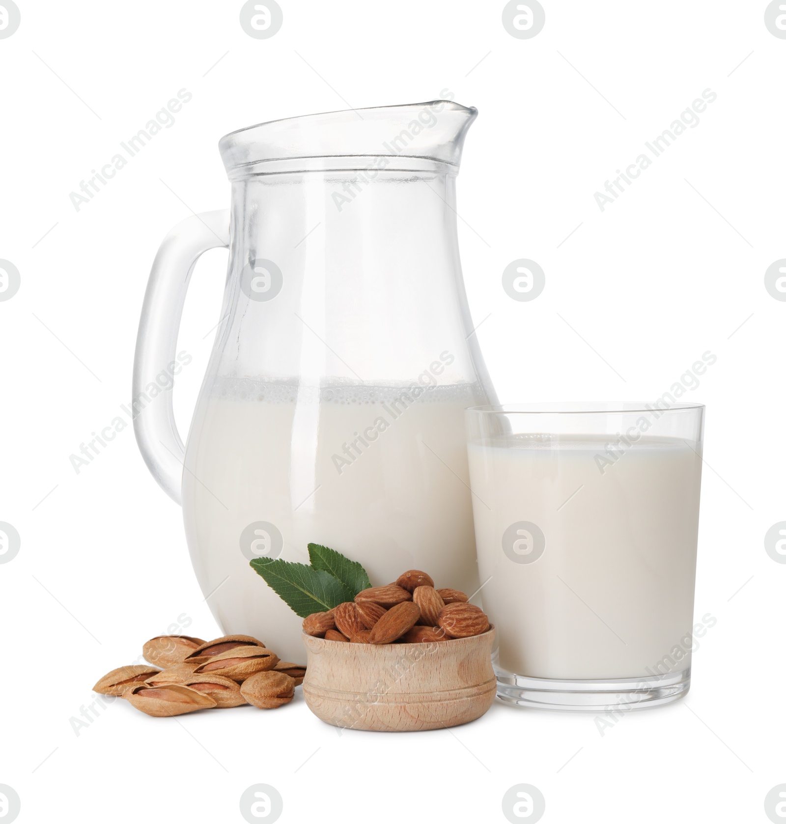 Photo of Glass of almond milk, jug and almonds isolated on white