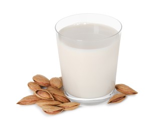 Glass of almond milk and almonds isolated on white