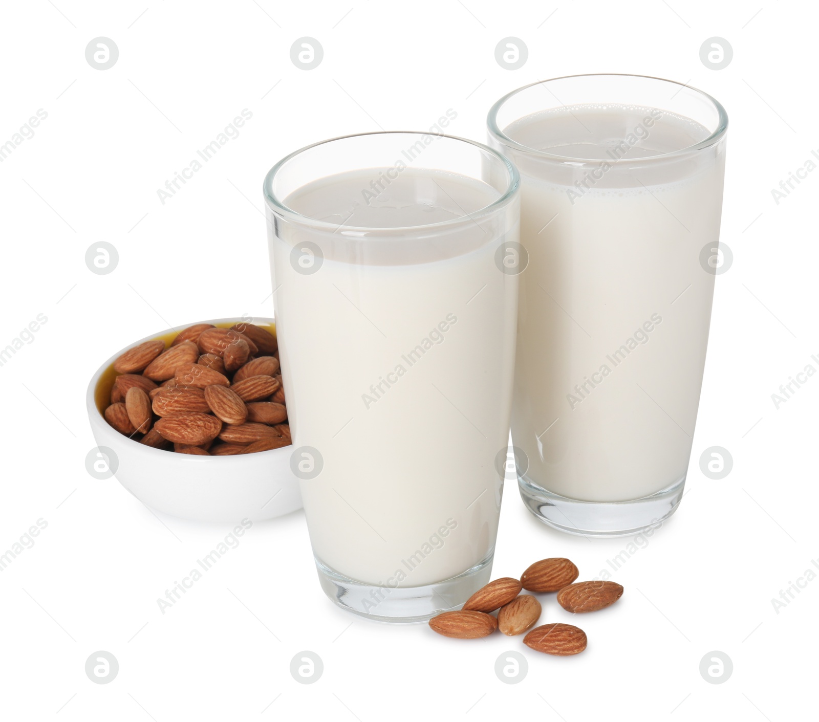 Photo of Glasses of almond milk and almonds isolated on white