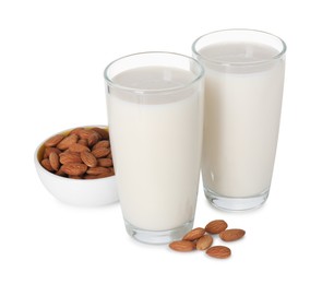 Photo of Glasses of almond milk and almonds isolated on white