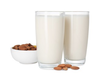 Photo of Glasses of almond milk and almonds isolated on white