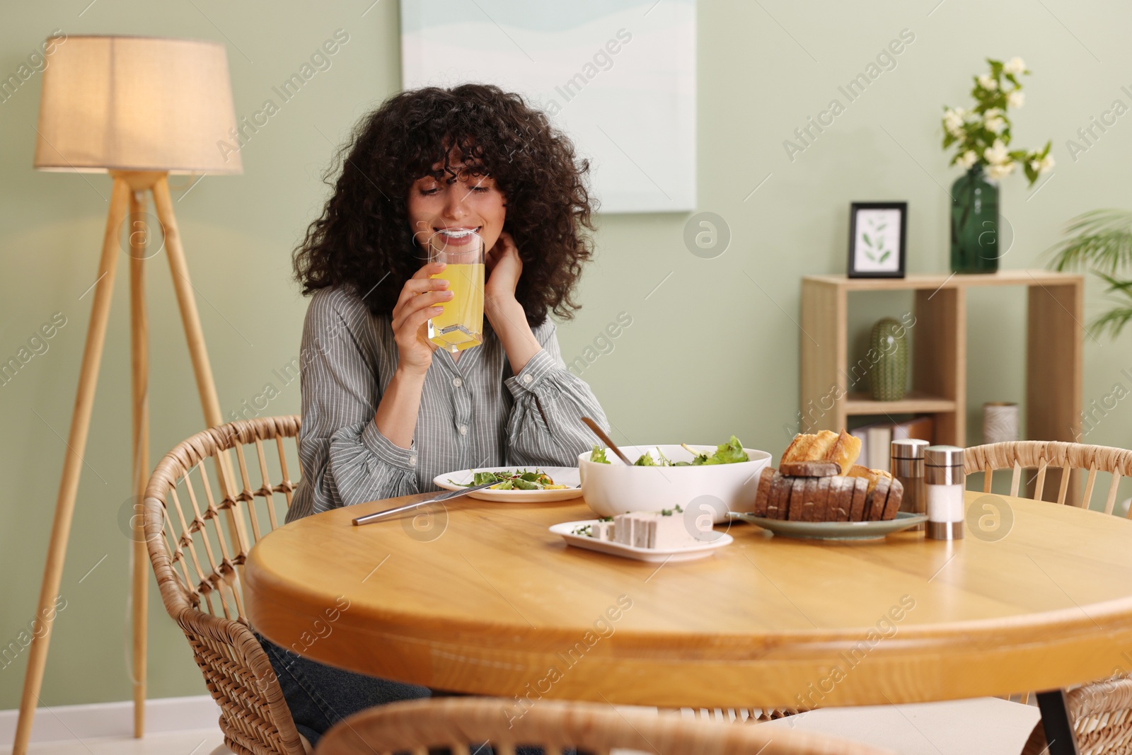 Photo of Woman having vegetarian meal at table in cafe