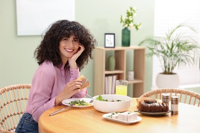 Woman having vegetarian meal at table in cafe