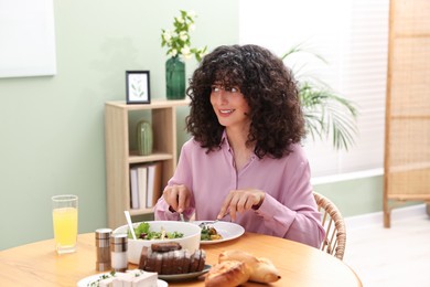Woman having vegetarian meal at table in cafe